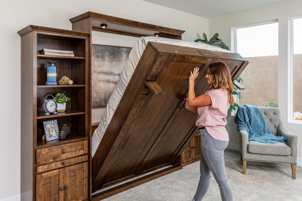 A fold-in murphy bed being used by a home owner to maximize small spaces in the home. 