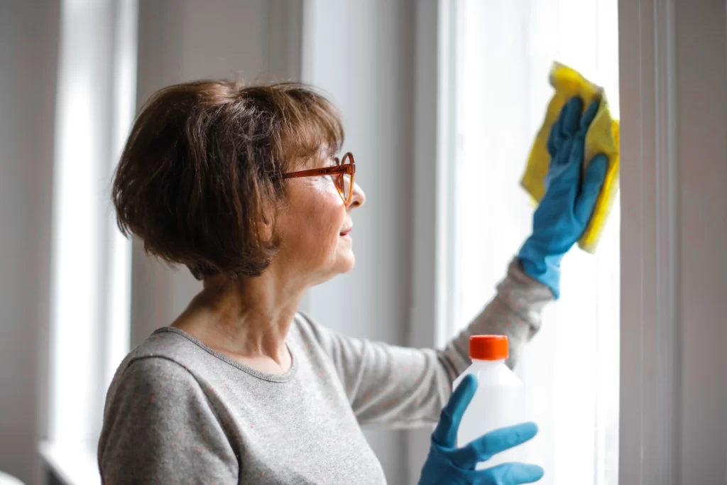 A longtime homeowner taking steps to maintaining their windows with proper cleaning techniques.