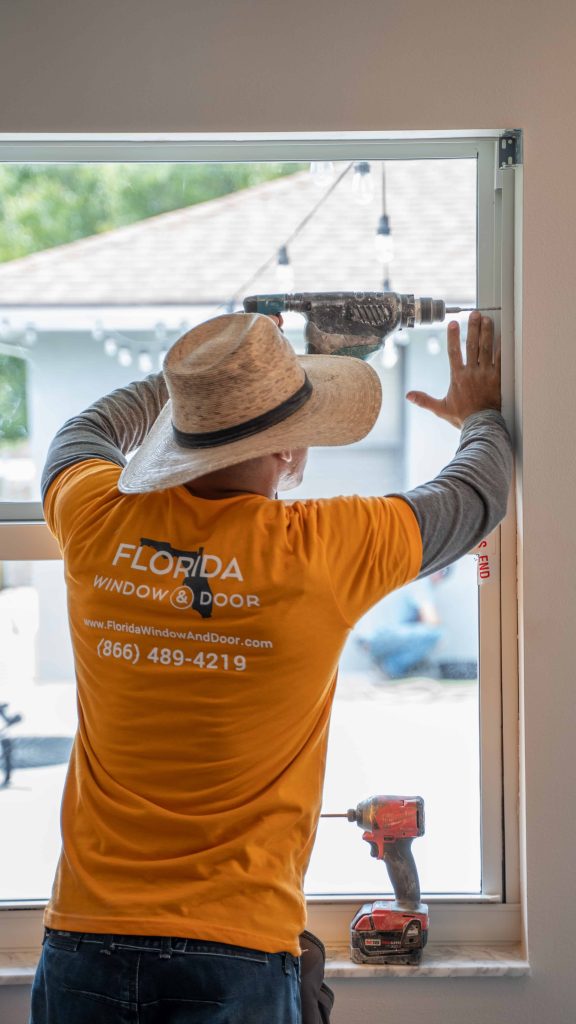 Worker for Florida Window & Door installing a brand new impact window.