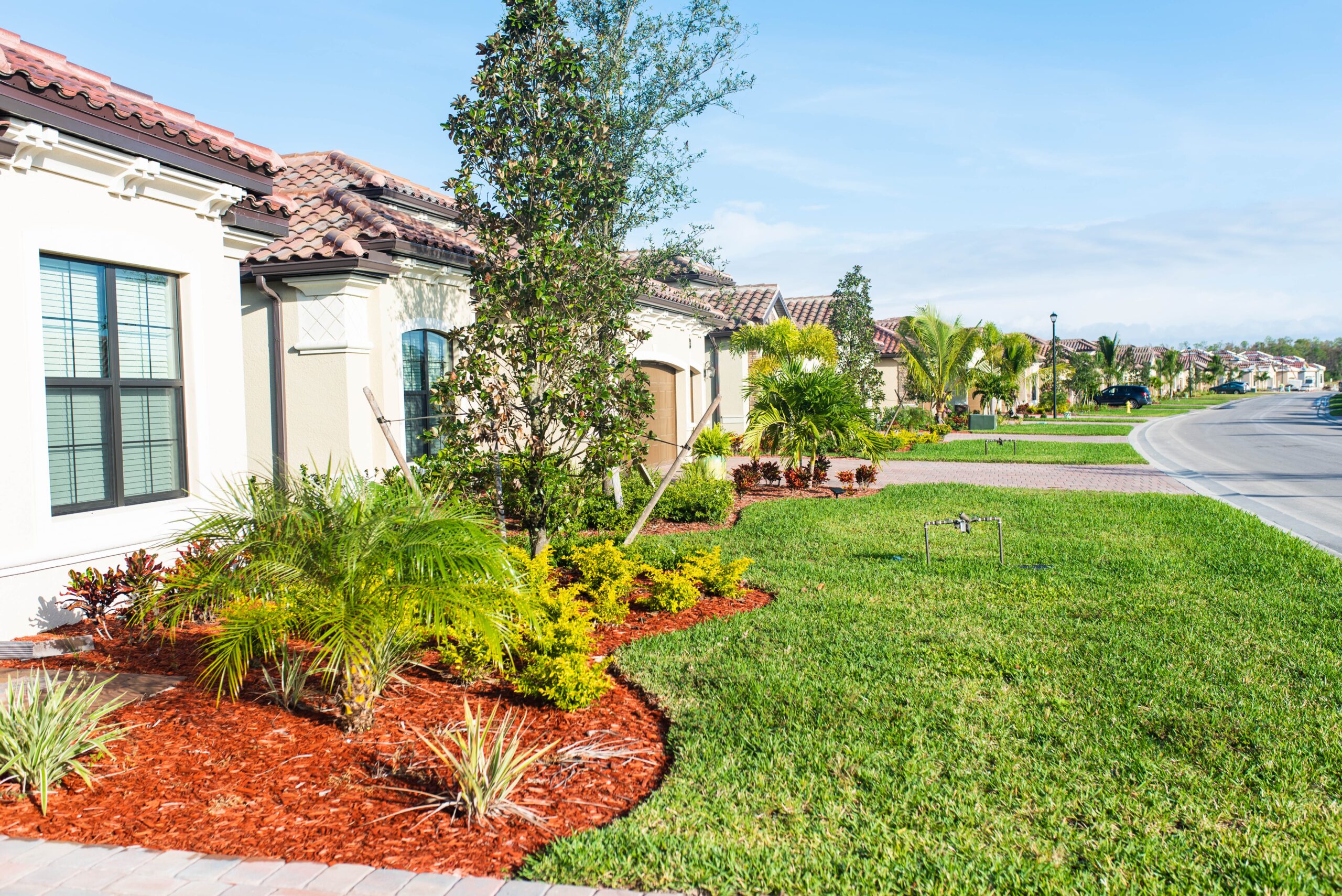 Florida home with landscaped lawn and mulch beds