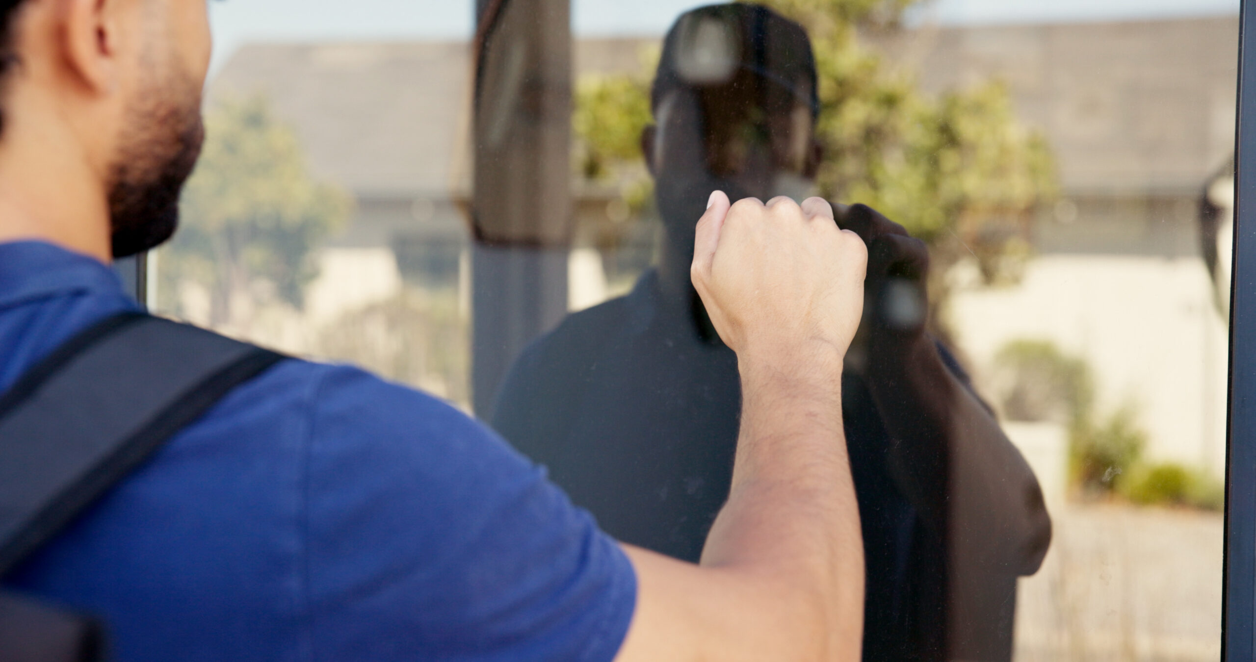 Man inspecting a home window for security